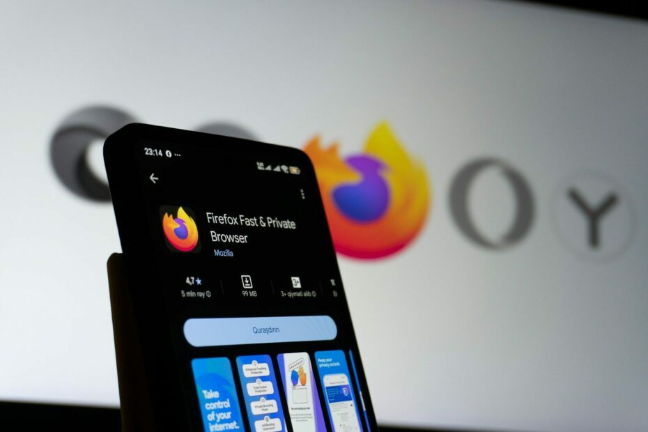 Smartphone displaying firefox browser with company logo in background