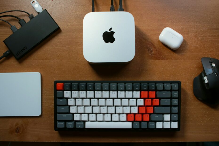 A computer keyboard and mouse on a desk
