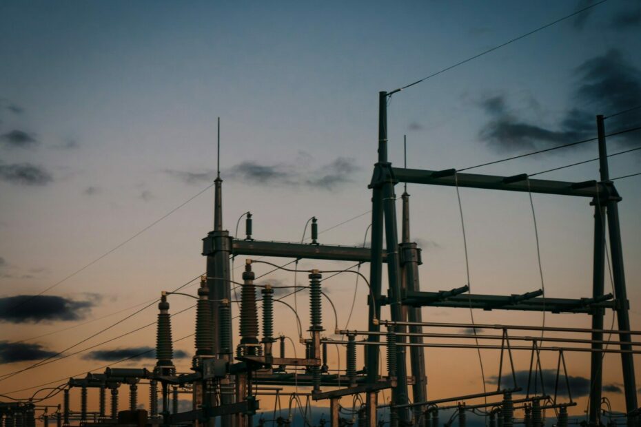 a group of power lines with a sky in the background